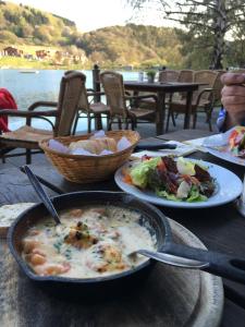 a table with a bowl of soup and a plate of food at Ferienwohnung Ankerplatz in Rieden