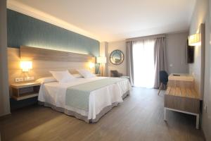 a hotel room with a large bed and a window at Hotel Puerta del Mar - Adults Recommended in Nerja