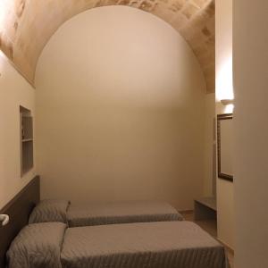 a bedroom with two beds in a room with a ceiling at B&B San Potito in Matera