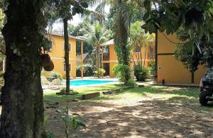 una casa con piscina en un patio en Apartamento em Condomínio Praia de Boiçucanga Litoral Norte en Boicucanga