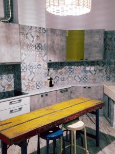a kitchen with a wooden table and two stools at Kolonaki Deco Apartment in Athens