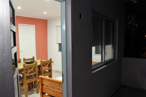 a door leading into a dining room with a table at Departamento Monte Hermoso in Monte Hermoso