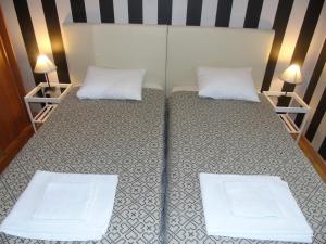 a bedroom with a bed with two white pillows at Apartment Lemos in Faro