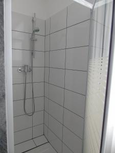 a bathroom with a shower with white tiles at Apartment Lemos in Faro