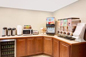 a kitchen with a counter with a microwave and a refrigerator at Knights Inn Traverse City in Traverse City