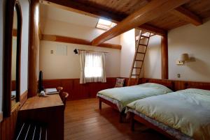 a bedroom with two beds and a ladder at とびた荘 #小学生以下は宿泊不可# in Oarai