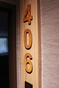 a wooden number on the side of a door at Royal Rose Hotel Shuangcheng Hall in Taipei