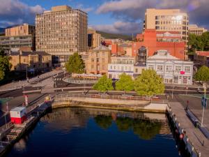 
a cityscape of a city with a river and buildings at Customs House Hotel in Hobart
