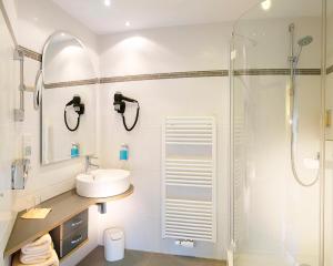 a bathroom with a sink and a shower at Hotel Linderhof in Erfurt