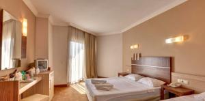 Postel nebo postele na pokoji v ubytování Magic Sun Hotel