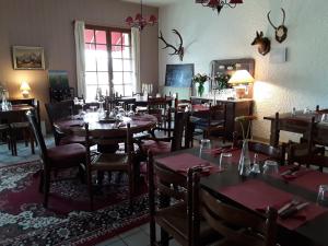 a restaurant with tables and chairs in a room at Relais Motel de Maisonnay in Maisonnay