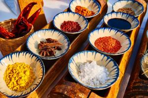 
a wooden table topped with bowls of food at Chen Sea Resort & Spa Phu Quoc in Phú Quốc
