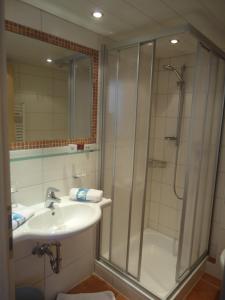 a bathroom with a shower and a sink and a shower at Pension Susanne in Sankt Anton am Arlberg