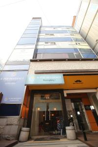 a store front of a tall building at K-POP Residence Myeongdong 1 in Seoul