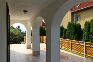 an external view of a house with arches at Napfény villa in Balatonfüred