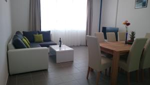 a living room with a table and a couch at Beautiful Apartment Jukic in Podstrana