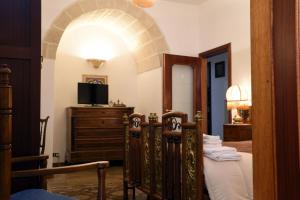 a bedroom with a bed and a tv on a dresser at Villa Elide in Ginosa Marina