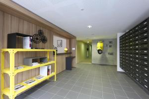 a room with a yellow shelf and a yellow motorcycle on the wall at Apparteo Dijon in Dijon