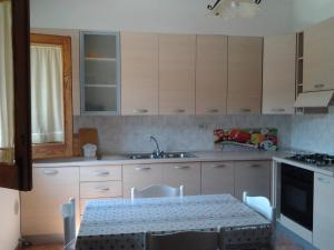 a kitchen with a table and a sink at Casa Vacanze Campagna&mare in Pollina