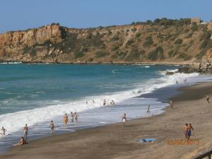 a group of people playing in the water at a beach at Casa Vacanze Campagna&mare in Pollina