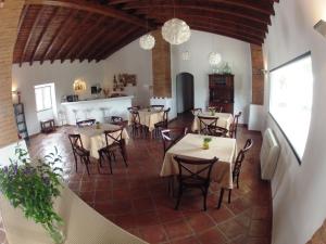 a restaurant with tables and chairs in a room at Outeiro Da Vila - Casas De Campo in Vila Verde de Ficalho