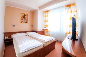 Posteľ alebo postele v izbe v ubytovaní Hotel Vsacan