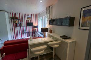 a living room with a red couch and a desk at Ittertal Apartment in Solingen