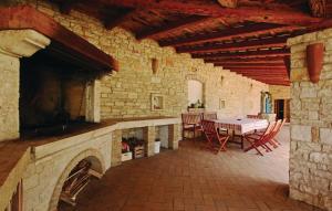 a patio with a table and chairs in a stone building at Villa Dusan 1212 in Svetvinčenat