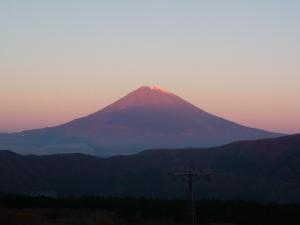 a mountain in the distance with a sunset at HAKONE GORA ONSEN Hotel Kasansui in Hakone