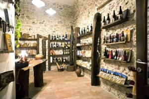 a wine tasting room with bottles on the wall at Residenza d'Epoca Borgodifiume in Fiumefreddo Bruzio