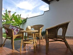 a group of chairs and a table on a patio at Casas Marin in Conil de la Frontera