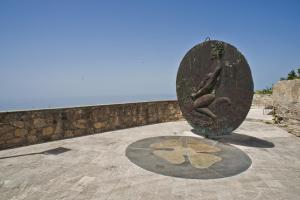 a statue of a person sitting on a rock at Residenza d'Epoca Borgodifiume in Fiumefreddo Bruzio