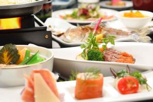 a bunch of plates of food on a table at Towada Hotel in Kosaka