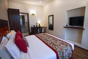 A bed or beds in a room at Devraj Niwas