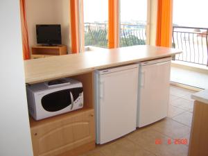 a kitchen with a counter top and a microwave at Panoramic Penthouse Sozopol in Sozopol
