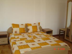 a bedroom with a bed with a quilt on it at Panoramic Penthouse Sozopol in Sozopol