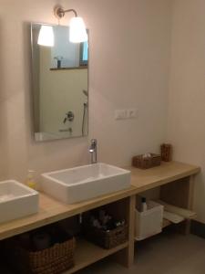 a bathroom with a white sink and a mirror at Garden Apartment in Greve in Chianti +18 photos