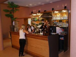 a group of people standing at a bar at Zajazd Orchidea - Hotel 24h in Lipsko