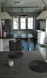 a kitchen with a table and a counter top at L'Auréthan in Vielsalm