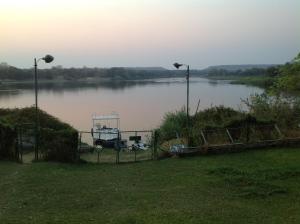 a boat sitting on a lake with at Sundowner Lodge in Hwange