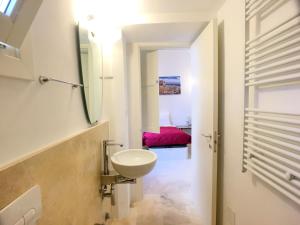 a white bathroom with a sink and a mirror at Dimore Nonna Ina in Maglie +27 photos