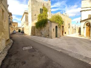 an empty street in an old building with a building at Dimore Nonna Ina in Maglie