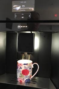 a coffee cup sitting on top of a coffee maker at Ronas House in Inverness