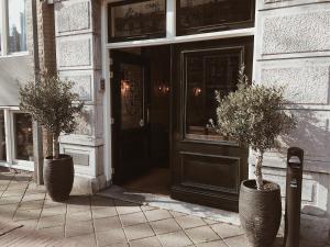 two potted plants sitting in front of a door at Mr. Jordaan in Amsterdam