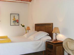 a bedroom with a bed and a table with a lamp at Hotel Rural Can Maries in Puerto de San Miguel