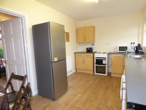 a kitchen with a large stainless steel refrigerator at Beckley House in Nottingham