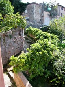 a view of a garden with trees and buildings at Casa "Le tre Muse" in Deruta