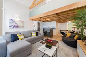 a living room with a couch and a table at LovelyStay-Modern Loft City Center in Porto
