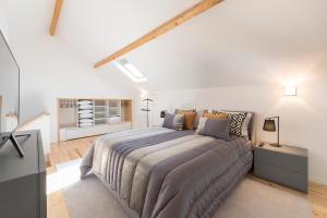 a bedroom with a large bed in a white room at LovelyStay-Modern Loft City Center in Porto +33 photos