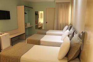 Tempat tidur dalam kamar di Hotel Maysa Caruaru
